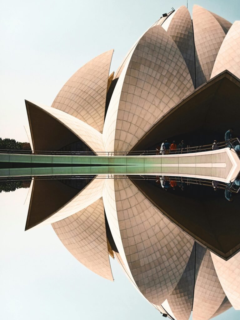Stunning view of the Lotus Temple in New Delhi with a perfect reflection in calm water.