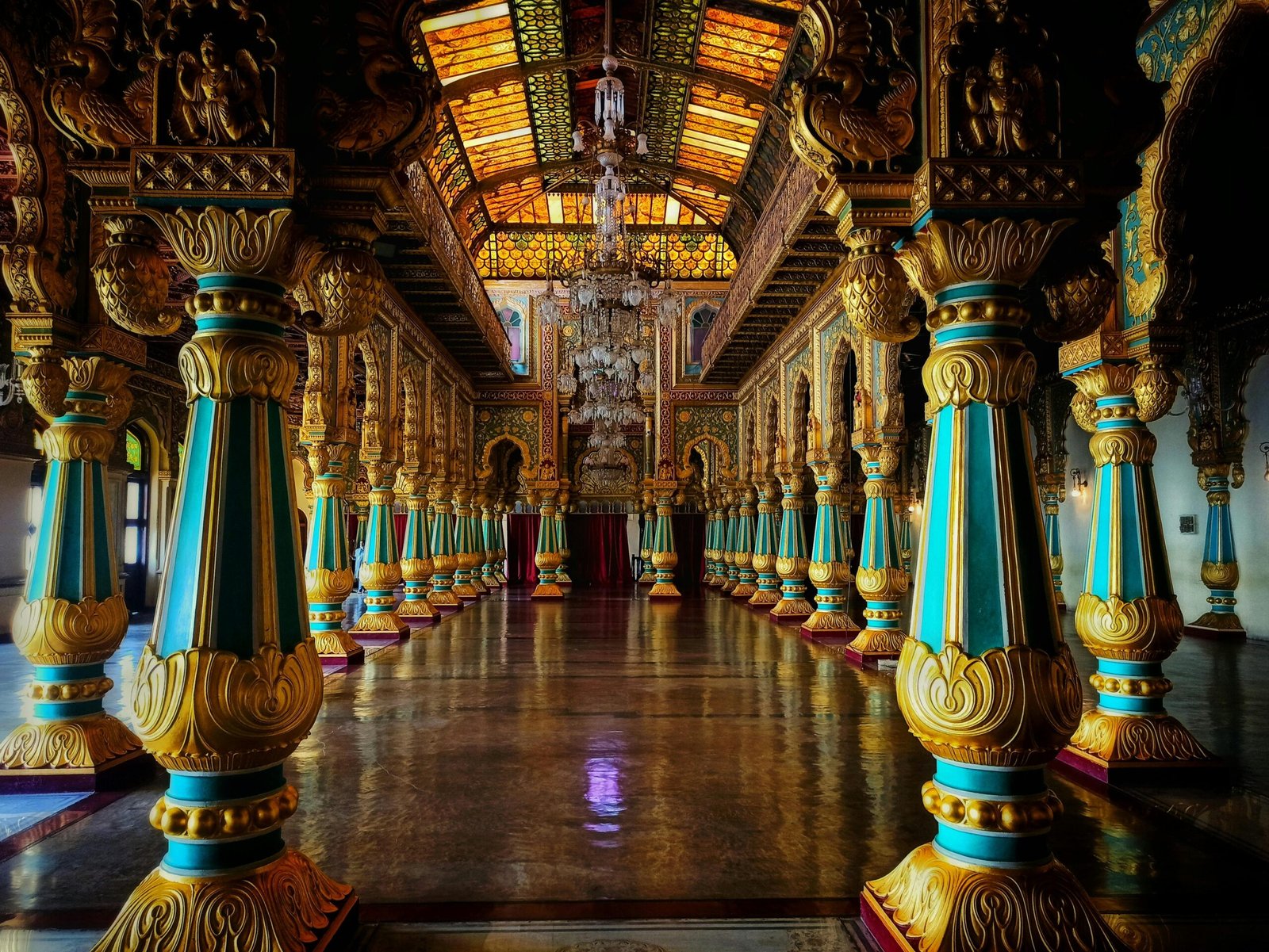 Stunning view of Mysore Palace's Private Durbar Hall showcasing colorful pillars and intricate details.