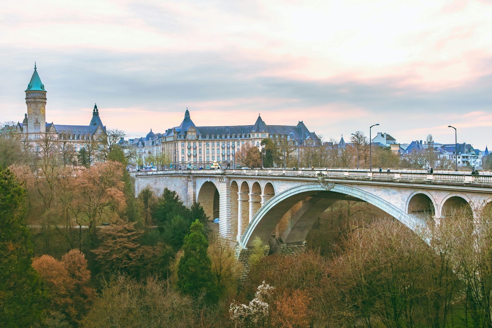 Scenic view of the iconic Adolphe Bridge amidst fall foliage in Luxembourg City.
