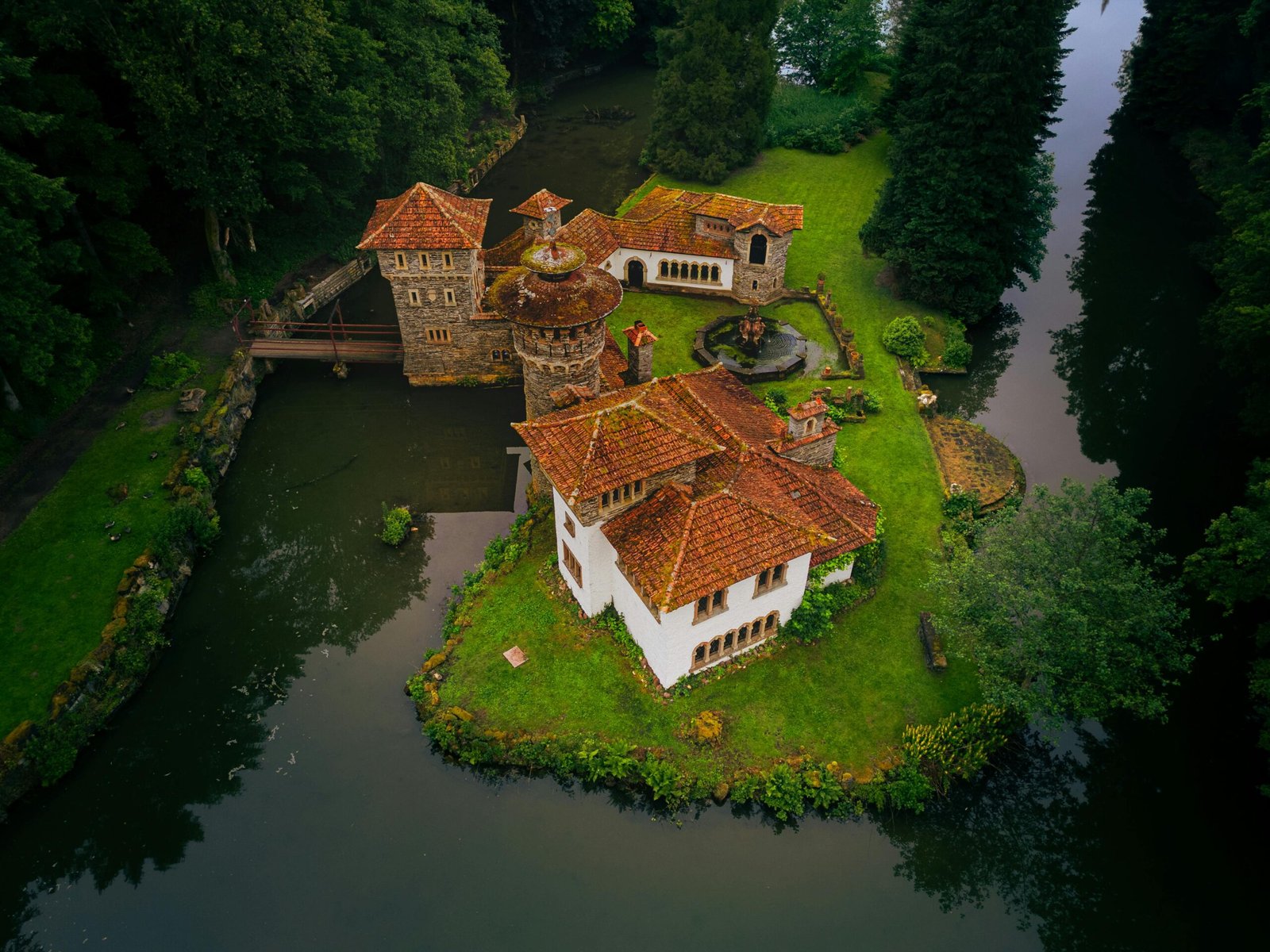 A stunning aerial shot of a historic castle surrounded by lush greenery in Luxembourg.